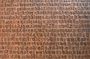 background with ancient sanskrit text etched into a stone tablet in a public square